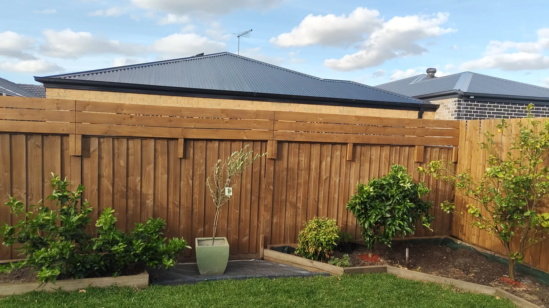Timber fence extension with decorative topper for added privacy