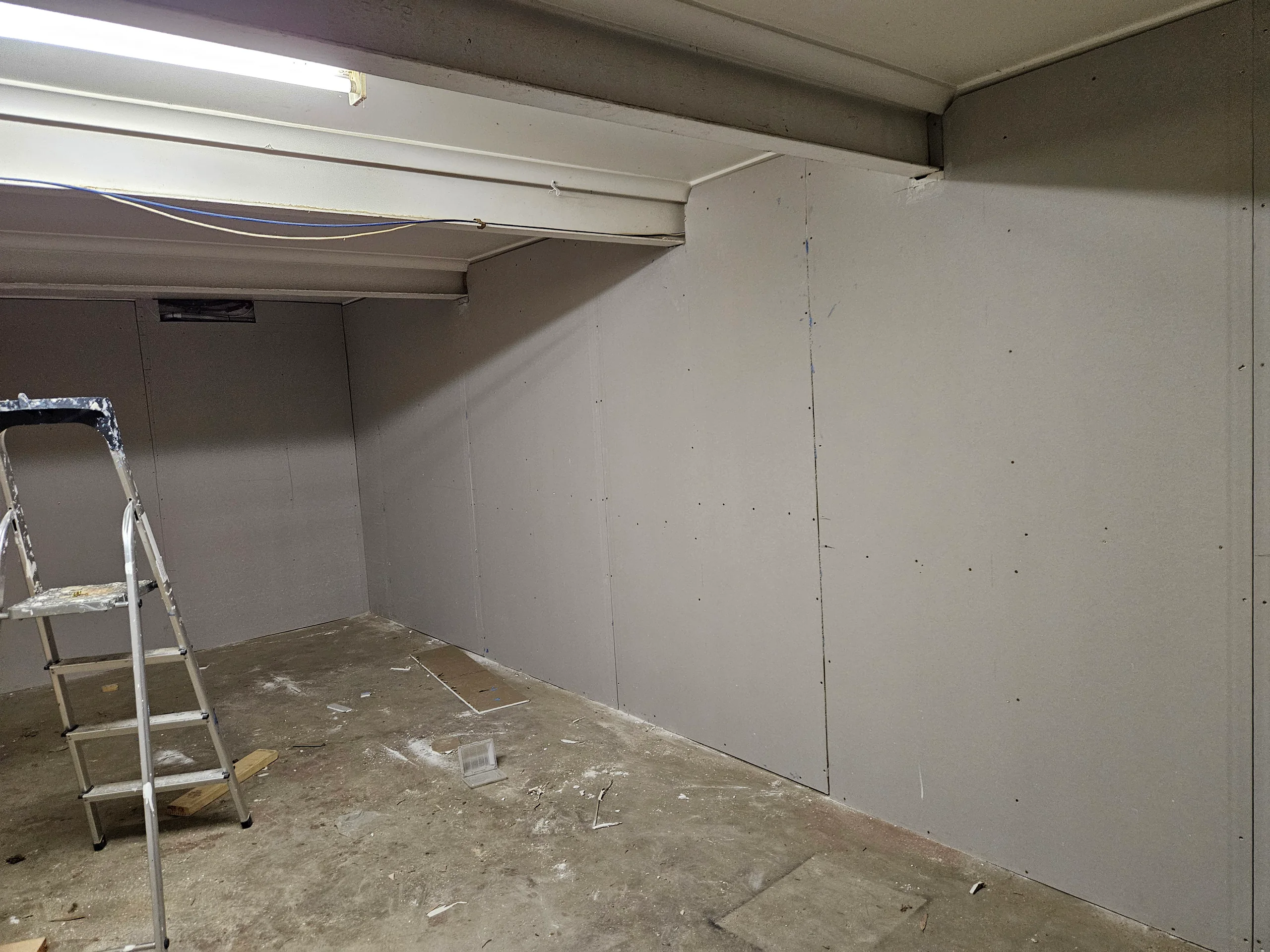 Storage space converted to a lined and plastered living room